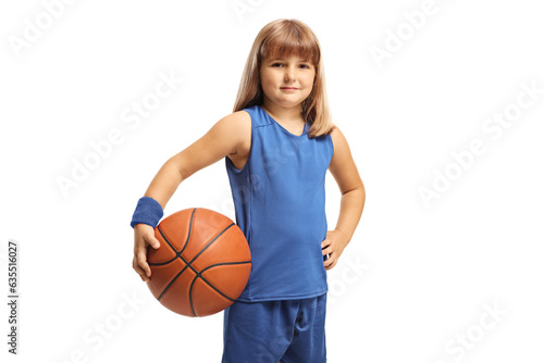 Girl in a blue sports jersey holding a basketball and smiling at camera