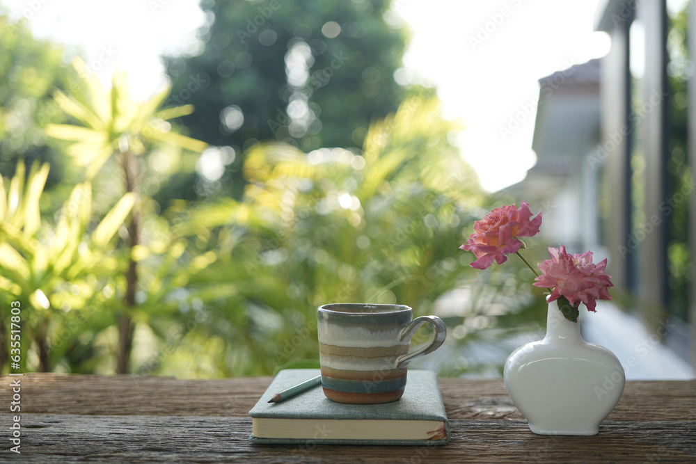 Coffee and vase of Rose on wooden table Coffee and vase of Rose on wooden table