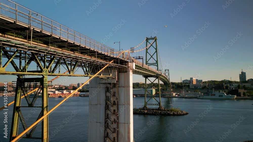Cinematic Drone Shot on of the Angus L. Macdonald Bridge Crossing the Ocean Harbor and Connecting the Two Cities of Halifax and Dartmouth During a Beautiful Summer Sunset, Canada. Cinematic Drone Shot on of the Angus L. Macdonald Bridge Crossing the Ocean Harbor and Connecting the Two Cities of Halifax and Dartmouth During a Beautiful Summer Sunset, Canada.