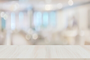 Wooden table on blur window glass white wall in office room. Empty luxury wooden table top shelf for display or montage products banner mock up background