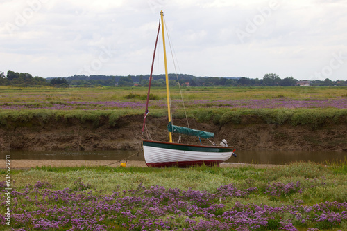 Sailing dinghy at low tide, in the salt marshes of Norfolk