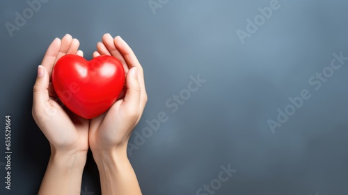 hand holding red heart, love passing photo