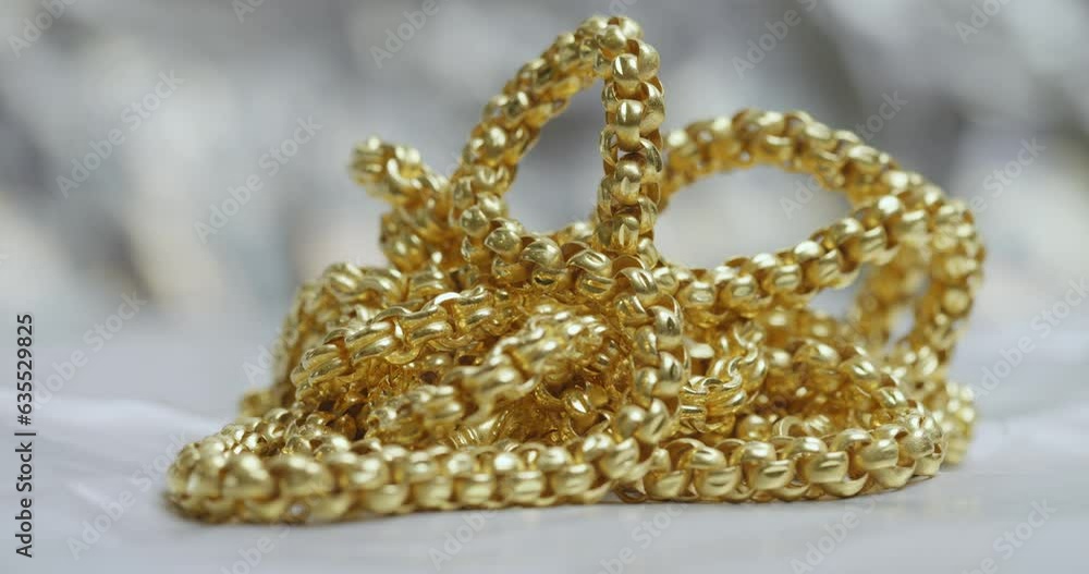 Closeup shot of gold necklaces with rotating
Closeup shot of gold necklaces with rotating