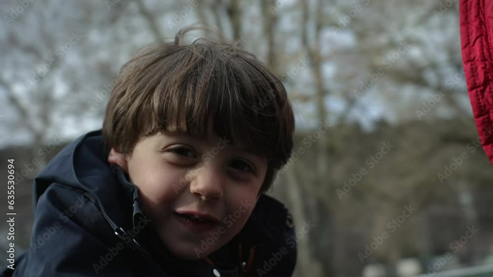 Delighted Child on Fall Park Roundabout, Close-up of Caucasian Boy, merry-go-round spinning, kid's face in motion Delighted Child on Fall Park Roundabout, Close-up of Caucasian Boy, merry-go-round spinning, kid's face in motion