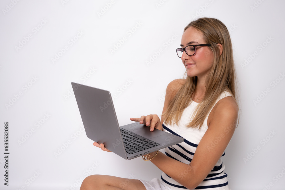Image of cheerful young woman sitting on floor isolated over white background using laptop computer. Image of cheerful young woman sitting on floor isolated over white background using laptop computer.