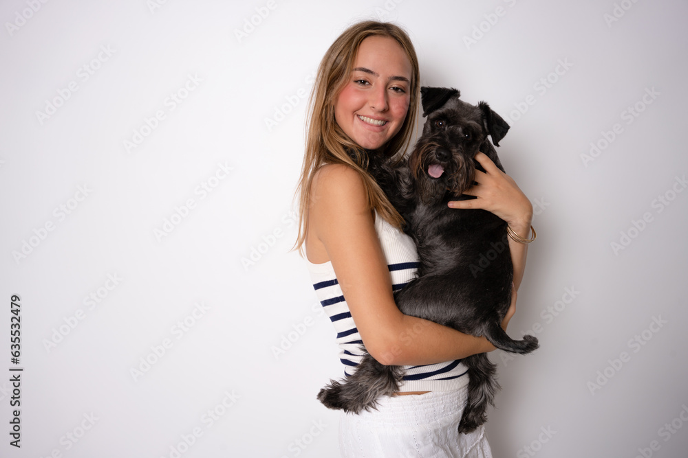 Positive female with glad expression and her dog being satisfied after walk outdoor, have good relationships, isolated over white background. Domestic animals and people. Positive female with glad expression and her dog being satisfied after walk outdoor, have good relationships, isolated over white background. Domestic animals and people.