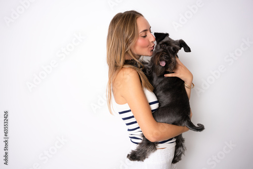 Positive female with glad expression and her dog being satisfied after walk outdoor  have good relationships  isolated over white background. Domestic animals and people.