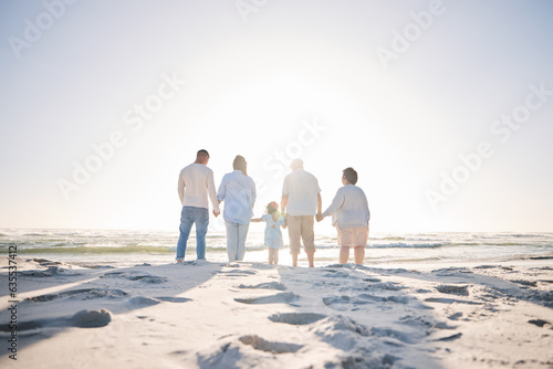 Summer, travel and holding hands with big family on beach for vacation, bonding and love. Freedom, care and relax with group of people walking at seaside holiday for generations, happiness and mockup