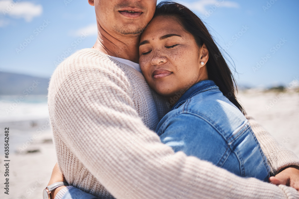 Fototapeta premium Love, hug and relax with couple at beach for travel, summer vacation and romance together. Calm, embrace and bonding with man and woman walking on seaside holiday for care, date or honeymoon