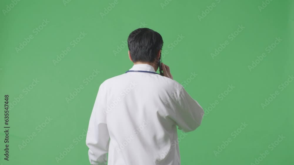 Back View Of Asian Male Doctor With Stethoscope Holding A Tablet While Walking On Green Screen Background In The Hospital
Back View Of Asian Male Doctor With Stethoscope Holding A Tablet While Walking On Green Screen Background In The Hospital