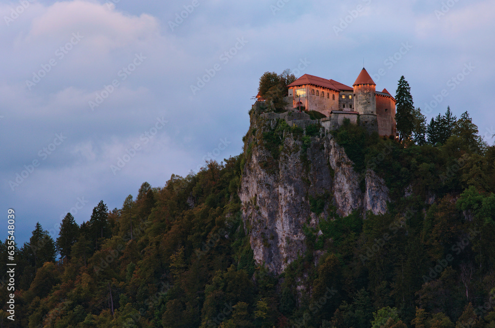 Picturesque landscape view of Bled Castle on top of a mountain with Lake Bled. The most famous lake in Slovenia. Famous touristic place and romantic travel destination. Cloudy weather