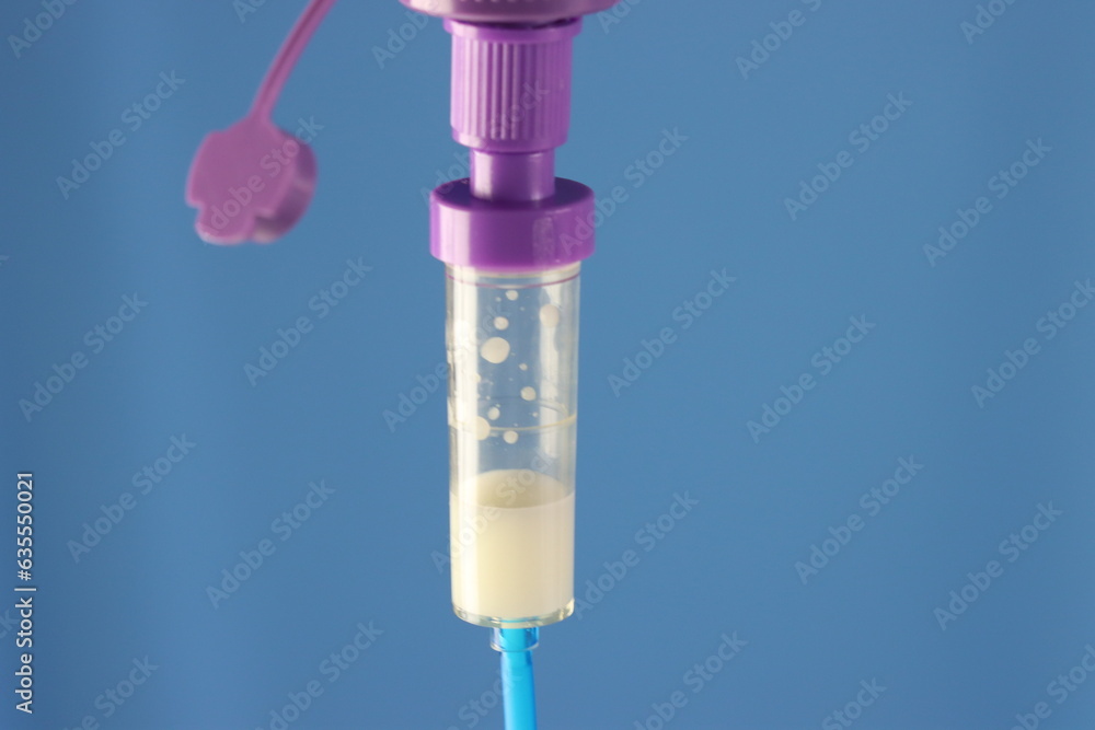 Close up view of the enteral diet bottle and and infusion set connected Close up view of the enteral diet bottle and and infusion set connected