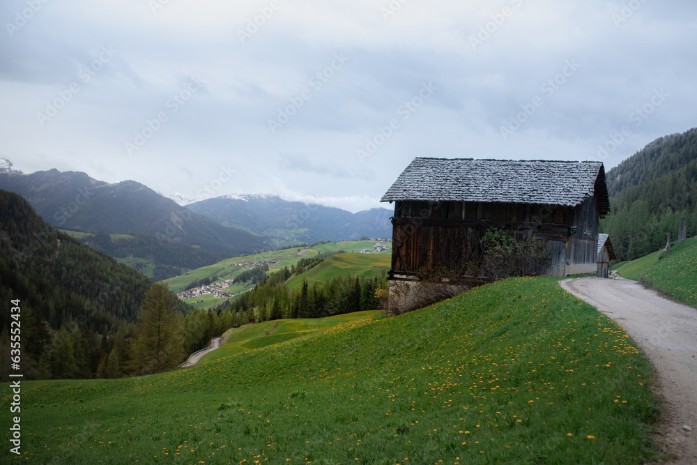 Alpine green meadows. Mountains and huts. Valley in the fog, cloudy. Nature Alpine green meadows. Mountains and huts. Valley in the fog, cloudy. Nature
