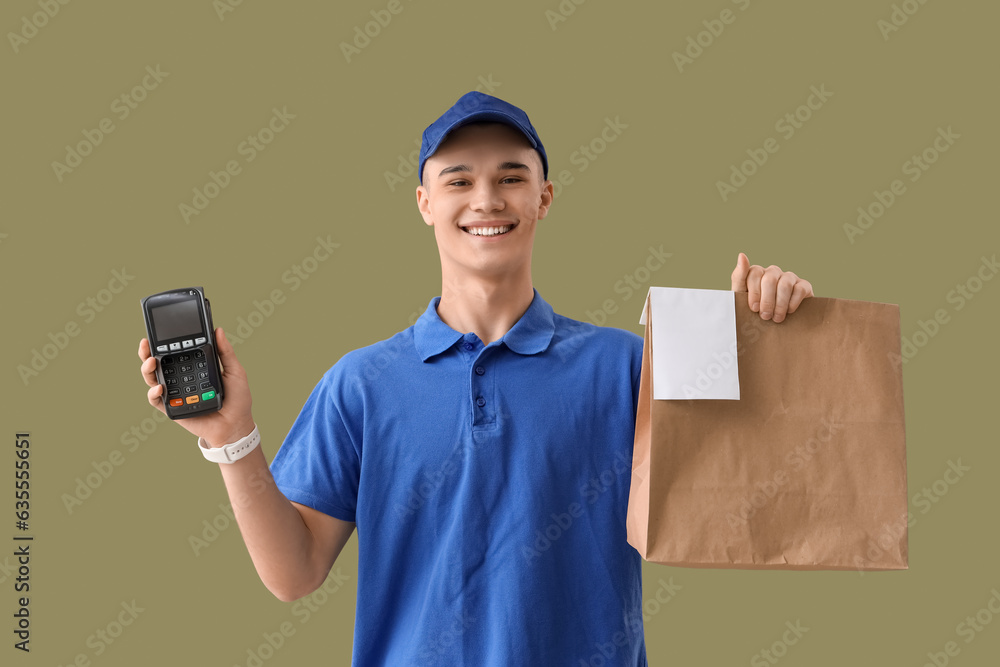 Young courier with paper bag and payment terminal on green background Young courier with paper bag and payment terminal on green background