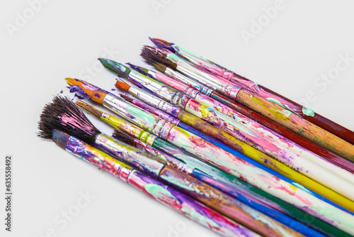 Dirty paint brushes on white background