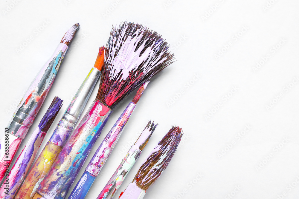 Fototapeta premium Dirty paint brushes on white background