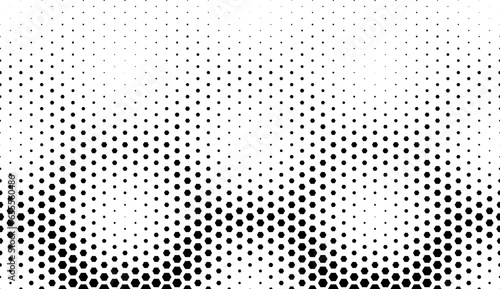 Disappearing seamless halftone vector background. Filled with black hexagones
