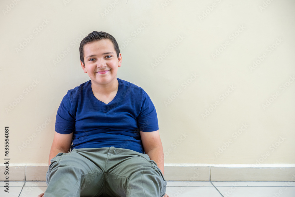 Portrait for a child sitting in the school corridor Portrait for a child sitting in the school corridor