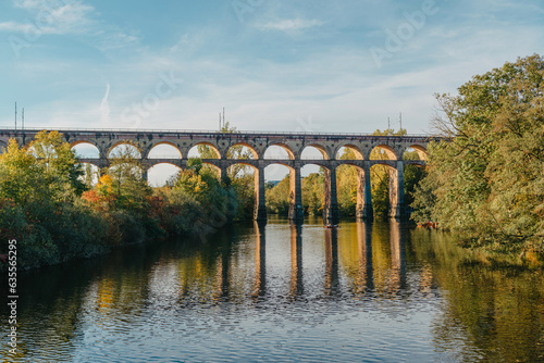 Railway Bridge with river in Bietigheim-Bissingen, Germany. Autumn. Railway viaduct over the Enz River, built in 1853 by Karl von Etzel on a sunny summer day. Bietigheim-Bissingen, Germany. Old