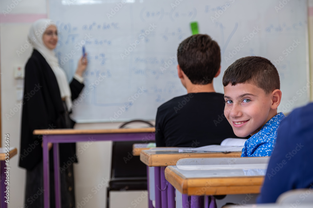 Boy studying in school with his colleagues Boy studying in school with his colleagues