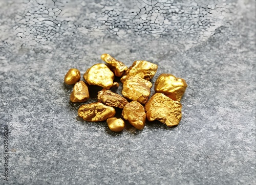 Heap of Gold Nuggets on Wooden Surface for Background, Closup of Mineral Pure Gold © Eggy