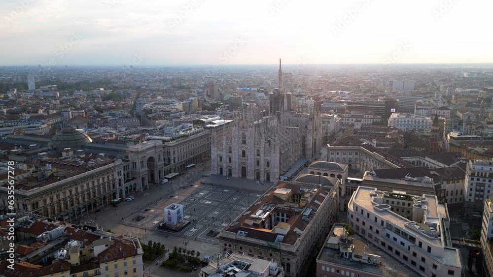 Europe, Italy, Milan - Aerial view of Piazza Duomo, gothic Cathedral in downtown center city. Drone aerial view of the gallery and rooftops during sunrise - Duomo Unesco Heritage sightseeing 