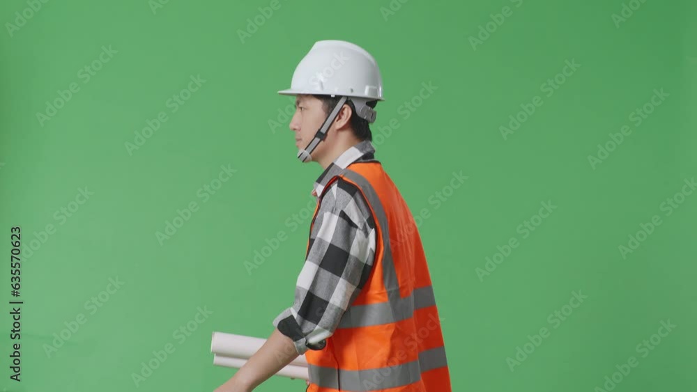 Side View Of Asian Male Engineer With Safety Helmet Holding Blueprint In His Hands And Looking Around While Walking In The Green Screen Background Studio
Side View Of Asian Male Engineer With Safety Helmet Holding Blueprint In His Hands And Looking Around While Walking In The Green Screen Background Studio