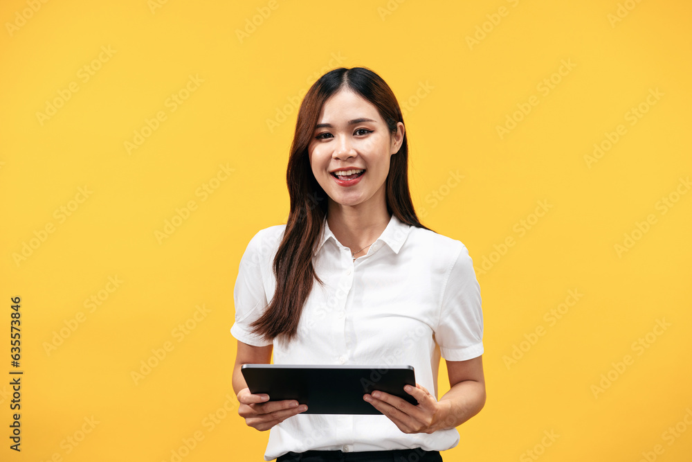 Young asian woman wearing white short sleeve shirt and holding tablet to working while standing to smiling Young asian woman wearing white short sleeve shirt and holding tablet to working while standing to smiling
