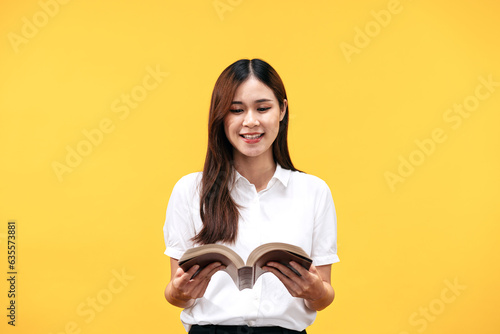 Young asian woman wearing white short sleeve shirt and holds holy bible to reading and praying to god