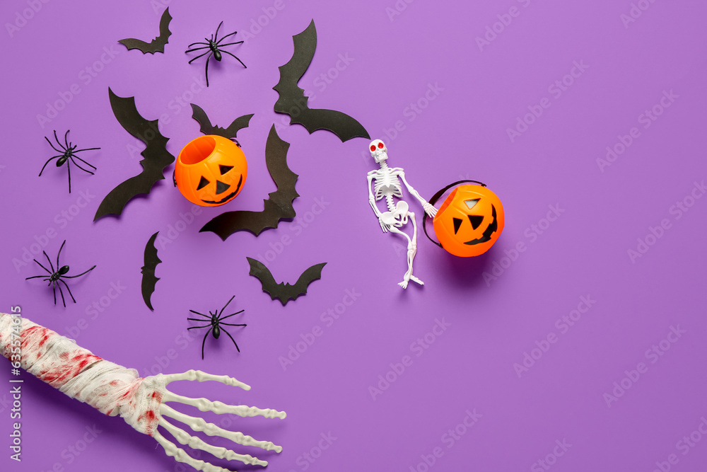 Composition with skeleton, hand, pumpkins, paper bats and spiders for Halloween celebration on purple background
