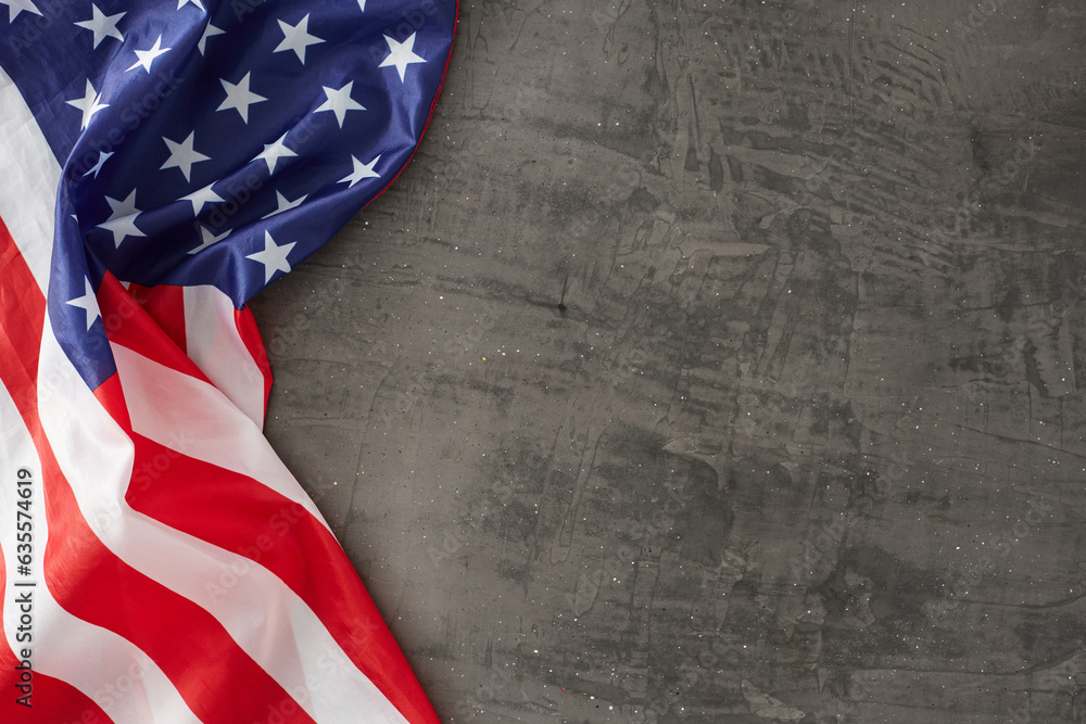 Obraz premium Crafting a vision for a celebratory Labor Day concept. Top view photo of USA national flag on concrete gray background with empty space for promo or text
