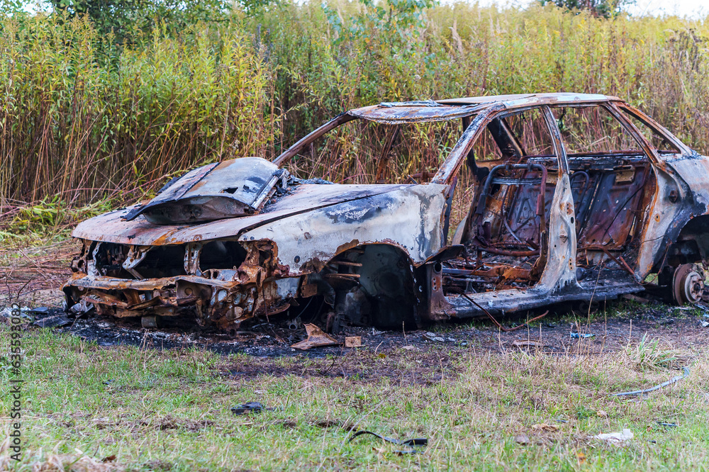 A burnt-out car. Fire burned car. Car old burned by fire.