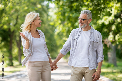 Portrait Of Happy Loving Mature Couple Walking Together On Path In Park