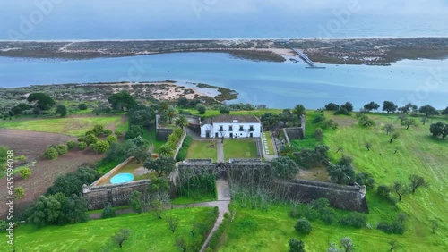 São João da Barra fort. Aerial view from a drone. Tavira cabins. Lighthouse district. Marshes and salt flats of the Ria Formosa Natural Park. Atlantic Ocean. Algarve. Portugal. Europe