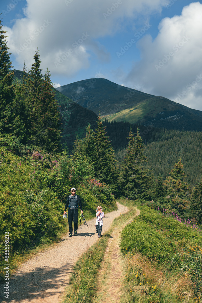father with daughter at mountain trail