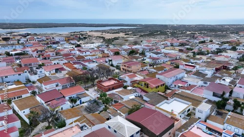 Aerial view of the port, church and Isla de La Culatra. Lighthouse district. Marshes and salt flats of the Ria Formosa Natural Park. Atlantic Ocean. Algarve. Portugal. Europe