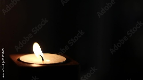 Close-up of flame burning on the candle isolated on a black background. Lighting wick with lighter
