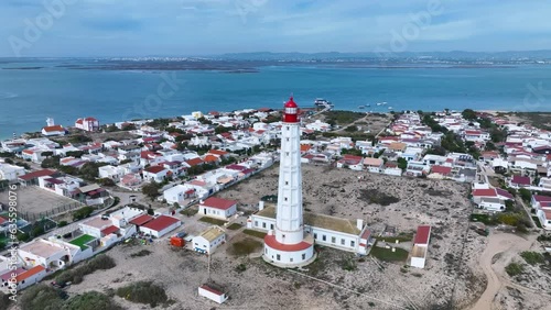 Cape Santa Maria Lighthouse. Aerial view of the lighthouse and the Isla de Faro. Lighthouse district. Marshes and salt flats of the Ria Formosa Natural Park. Atlantic Ocean. Algarve. Portugal. Europe