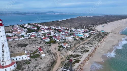 Cape Santa Maria Lighthouse. Aerial view of the lighthouse and the Isla de Faro. Lighthouse district. Marshes and salt flats of the Ria Formosa Natural Park. Atlantic Ocean. Algarve. Portugal. Europe