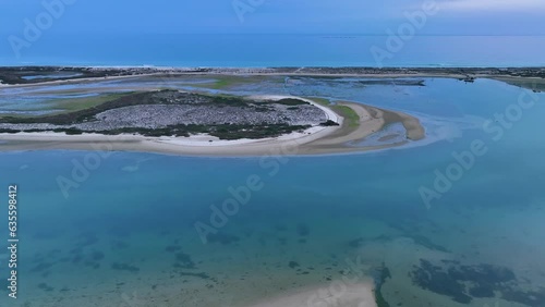 Sunset in Fuseta from an aerial drone view. Olhão Municipality. Lighthouse district. Marshes and salt flats of the Ria Formosa Natural Park. Atlantic Ocean. Algarve. Portugal. Europe