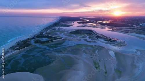 Sunset in Fuseta from an aerial drone view. Olhão Municipality. Lighthouse district. Marshes and salt flats of the Ria Formosa Natural Park. Atlantic Ocean. Algarve. Portugal. Europe