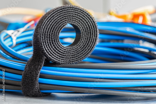 Bild auf Leinwand Roll of hook and loop, velcro tape with bundle of cables, electrical installatio