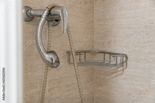 Well-Used Shower with Worn Shelf and Water Calcium Marks