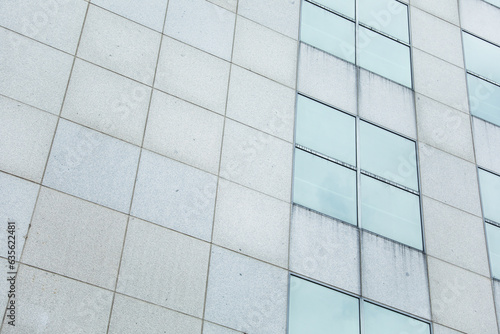 Glass-clad skyscraper represents modern real estate: growth, ambition, urbanization. Symbol of prosperity and industry in cityscape