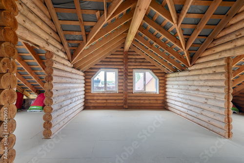 Log house interior under construction. Country house made of logs, interior without furniture © FedotovAnatoly
