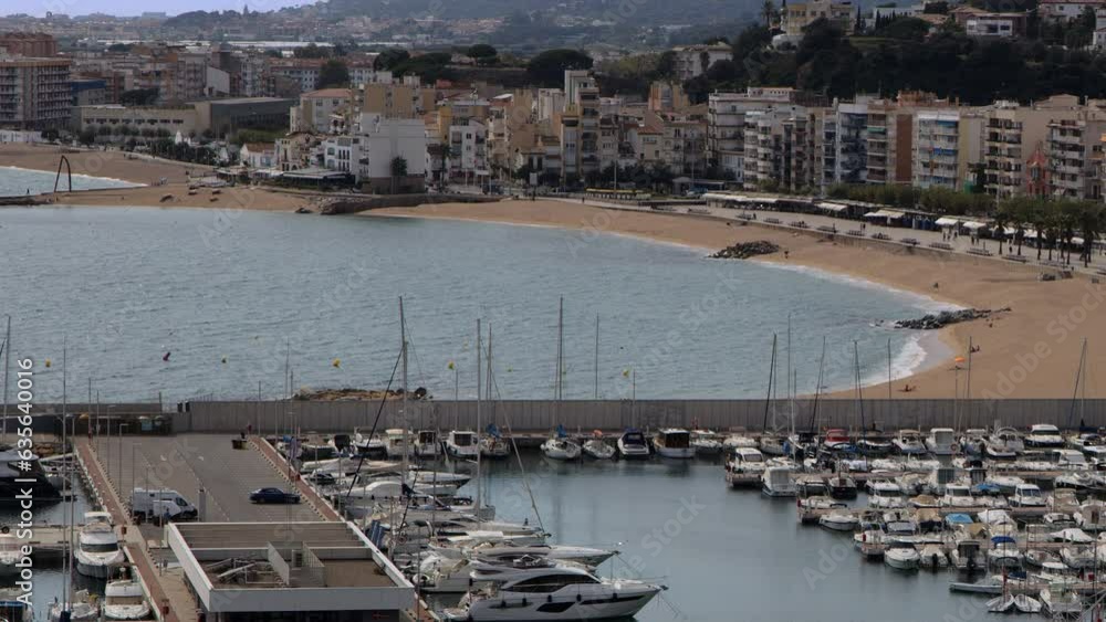 Landscape shot of Blanes, boats parked on piers of Blanes port. Costa Brava, Catalonia, Spain, Europe Landscape shot of Blanes, boats parked on piers of Blanes port. Costa Brava, Catalonia, Spain, Europe