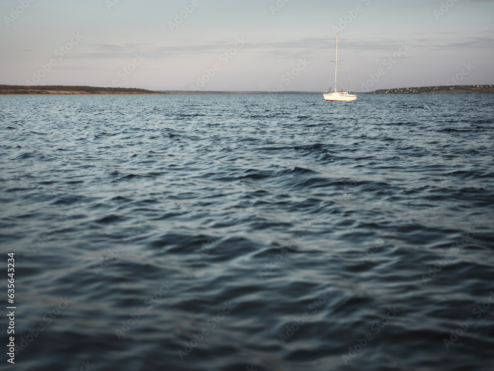 Obraz premium view to sailboat on the lake with little waves
