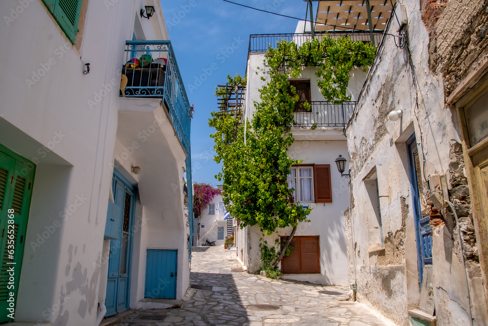 European streets-Tinos Island Greece, scenes of narrow cobblestone streets, restaurant patios, and whitewashed buildings