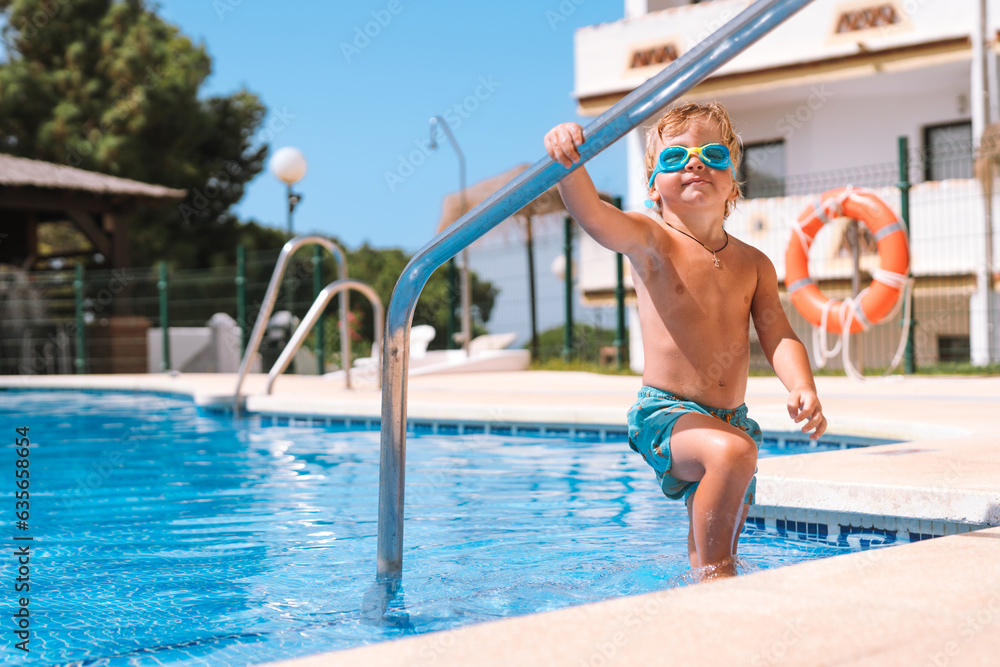 little boy enters the pool