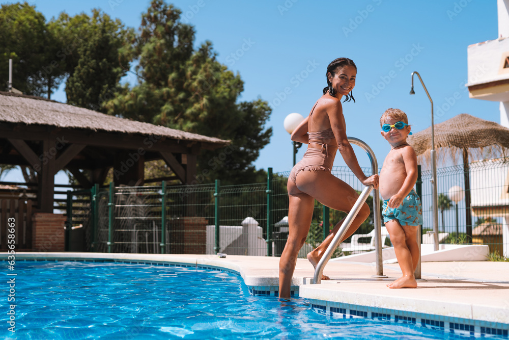 mother and son swimming in the pool